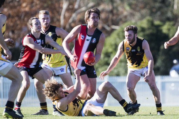 Ainslie's Jed Costigan looks to get the ball clear.