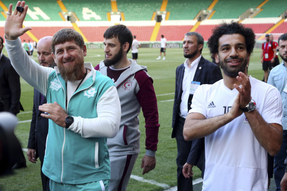 Playing the game: Mohammed Salah  and Chechen leader Ramzan Kadyrov  wave to fans.