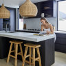 “Because of the open-plan living, and because there’s only two of us, we have all our meals at the kitchen bench,” says Kate. “It is one of my favourite spots.”  The kitchen bench is Caesarstone in “Cloudburst Concrete”, the lampshades are from Ur Place and the wooden stools are by Uniqwa Collections.