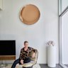 David Hicks seated on a 1970s Uginox lounge chair. The sculpture is by Narelle White and the copper glass disc is from eModerno.
