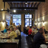 The dining room is a bona fide looker, all brooding leather, original terrazzo sandstone and cedar.