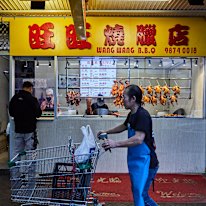 Roasted ducks and soy-glazed chickens hang alongside roasted pork at Wang Wang BBQ.