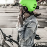 Woman putting her helmet.