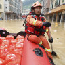 Rescuers deliver food by raft to people in Lianjiangkou, Guangdong Province.