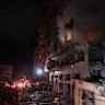 Smoke pours from a building after it was hit by Israeli airstrikes in the Al-Remal area in Gaza City.