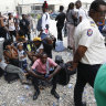 Haitians waiting to board a flight to Nicaragua gather after the government banned all charter flights to Nicaragua, at Toussaint Louverture International Airport in Port-au-Prince, Haiti.