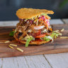 A crisp fried arepa split into two
discs hosts a variety of burger fillings.