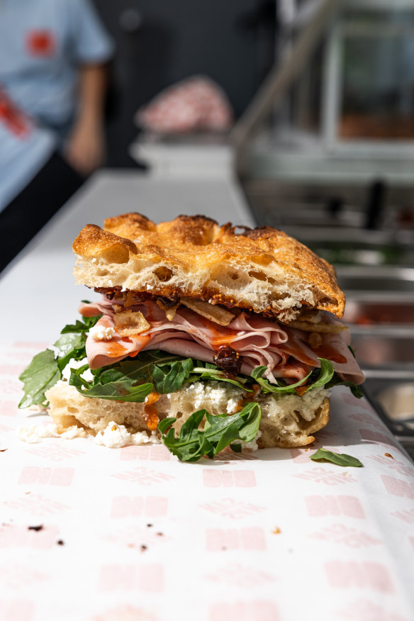 The mortadella sandwich with fig jam and potato chips.