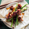 Char sui pork skewers with cucumber and sesame salad.