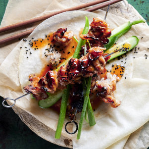 Char sui pork skewers with cucumber and sesame salad.