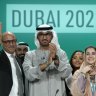 United Nations Climate Chief Simon Stiell, from left, COP28 President Sultan al-Jaber and Hana Al-Hashimi, chief COP28 negotiator for the United Arab Emirates, pose at the end of the COP28 U.N. Climate Summit, Wednesday, Dec. 13, 2023, in Dubai, United Arab Emirates. (AP Photo/Peter Dejong)