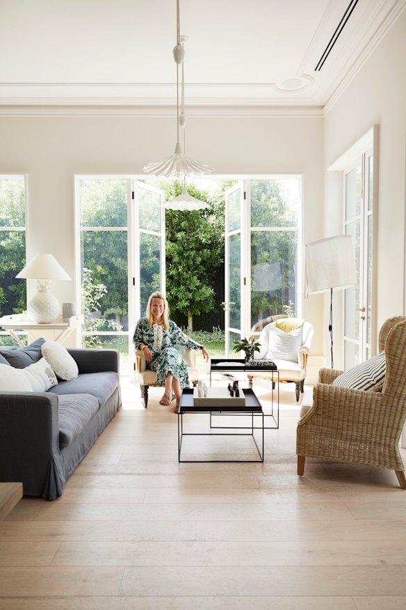 “I grew up in the country and my husband in the city; our home reflects both,” says Carrie Gourlay, seated in the open-plan space that opens out to a garden designed by Paul Bangay.