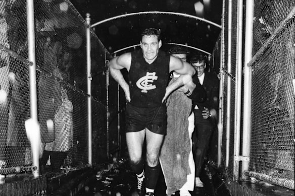 Walking off exhausted, in the rain and surrounded by fans after Carlton beat St Kilda at Princes Park in 1967.