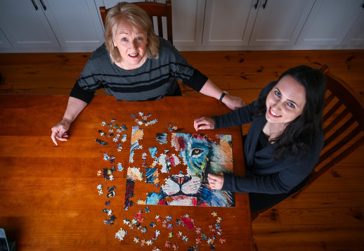 Competitive jigsaw puzzlers Bree Rebeiro, right, and her mother Jeanette Rebeiro practise at home.