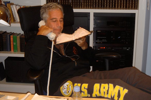 Jeffrey Epstein holds a cake in the shape of a woman’s breasts.