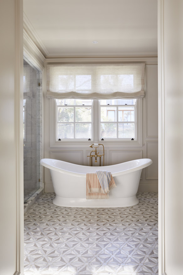 A free-standing Victoria + Albert “Marlborough” bath sits on 
a custom-made marble mosaic floor by Kate Walker Design. 