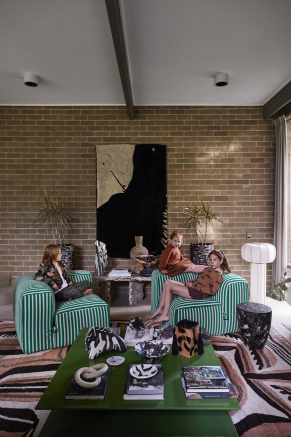 Simone Haag’s daughters (from left) Clover, Juniper and Goldie relax in the sunken lounge. The tapestry from Fundamente is flanked by Le Mura and Tacchini chairs from Stylecraft.