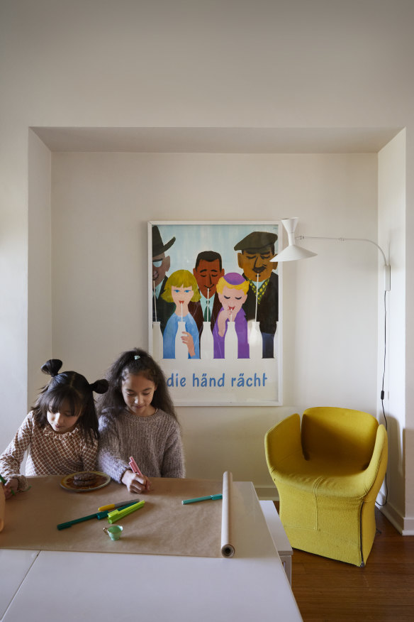 The dining table doubles as a craft space for Coco and Indigo. The vintage poster is by Herbert Berthold Libiszewski, and the chair is by Moroso from Hub.