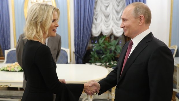 Russian President Vladimir Putin greets NBC News' Megyn Kelly before her interview with him in Moscow's Kremlin.