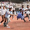 Disgruntled fans vandalise stadium chairs as they run on to the field after failing to get a glimpse of Argentine soccer star Lionel Messi.