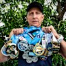 Mark Goodwin with his medals from years of competing in the Sydney Marathon, and his medal for finishing every major in the world.