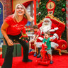 Merry work: Santa photographer Simone Morihovitis at work with Alex, 1, on rocking chair, and his brother Sam, 4.