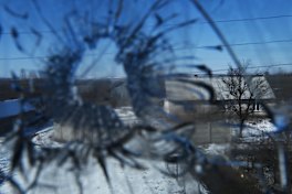 The shattered window of Olena Miroshnychenko’s home that was destroyed when mortars landed in her backyard in Kamyanka village in east Ukraine.