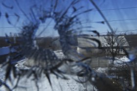 The shattered window of Olena Miroshnychenko’s home that was destroyed when mortars landed in her backyard in Kamyanka village in east Ukraine.