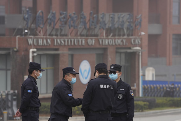 Security personnel gather near the Wuhan Institute of Virology earlier this year.