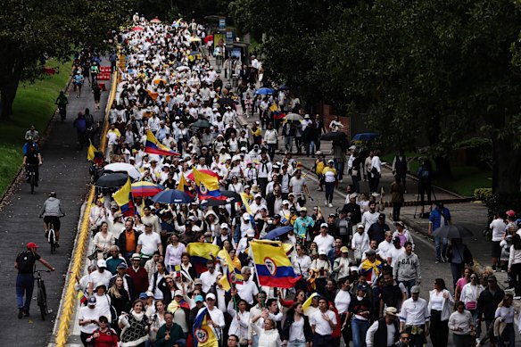 People march to the hospital where Colombian senator Miguel Uribe Turbay is being treated on Sunday.