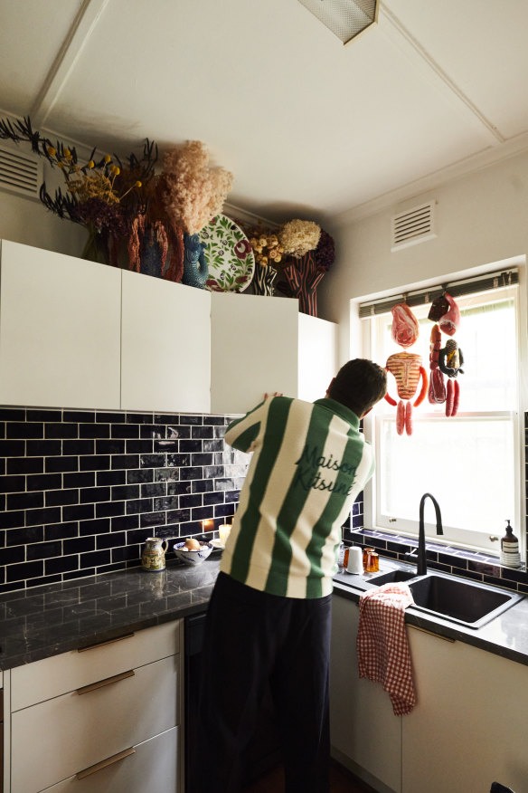 “We refreshed the kitchen during the COVID lockdowns, with new cabinets from Freedom
and subway tiles from Cerdomus,” says Elliott. The hanging sculptures are by Nathalie Lété.