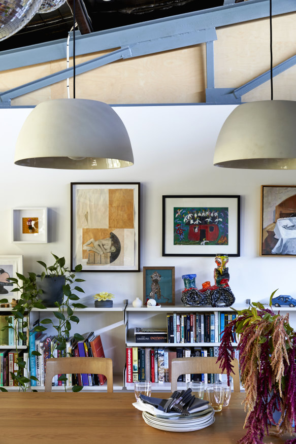 Mud pendant lights hang over a Barber Osgerby-designed table and chairs by
Maruni. The shelving is by Vitsoe, which Simpson uses exclusively in her shops.