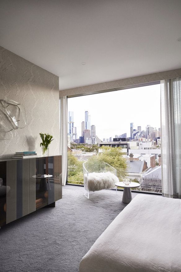 “The bedroom is a sanctuary of delicate texture, with beautiful views over the city, particularly at night,” says Hansen. The glass and steel sideboard is by Lago.