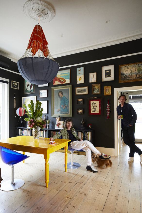 “We consider ourselves lucky to have access to amazing art,” says Moya Delany, in the dining room with husband Jason Buesst. The chairs are by Philippe Starck and the light is by Delany.