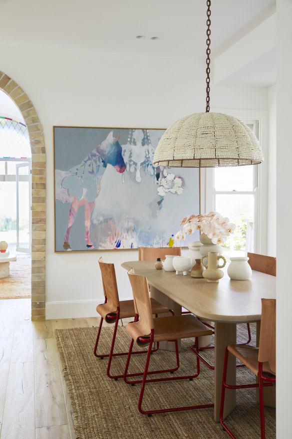“We love the red on our Dowel Jones chairs against our mint kitchen,” says Kerri. The table is from Jardan, the light from Klaylife and the art by Miranda Skoczek.