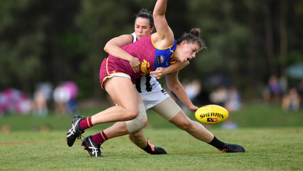 Tara Morgan puts the squeeze on Isabella Ayre of the Lions.