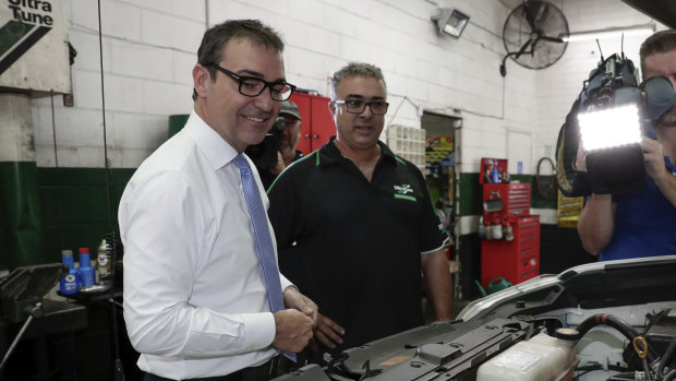 Liberal leader Steven Marshall speaks with Rocky Carbone, owner of an Ultra Tune car workshop on the eve of the South Australian election.