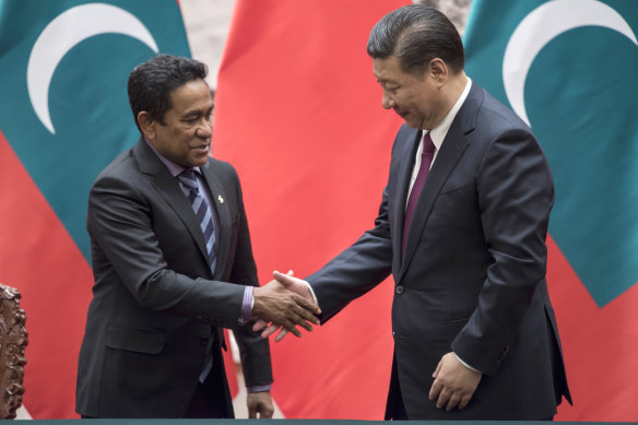 Maldives President Abdulla Yameen, left, shakes hands with China's President Xi Jinping in Beijing.
