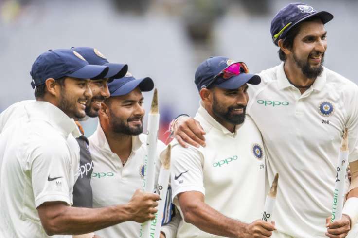 Mission accomplished: the tourists celebrate their 137-run victory at the MCG
