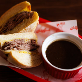 French dip sandwich with a side of gravy.