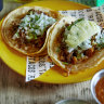 Chipotle barbacoa beef taco (left) and al pastor pork and pineapple taco.