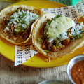 Chipotle barbacoa beef taco (left) and al pastor pork and pineapple taco.