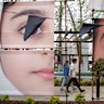 People pass an art installation featuring portraits of some of the Minab school girls killed in an apparent US strike in February, on April 12, 2026 in Tehran, Iran. On April 8 President Donald Trump announced a two-week ceasefire between the US and Iran, conditional on shipping being allowed to resume through the Strait of Hormuz. Peace talks held in Pakistan have since stalled, reportedly over Iran’s nuclear stockpile and continued blockade of the Strait of Hormuz.