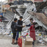 Palestinian children sell sweets outside a destroyed building in Jabaliya refugee camp in the Gaza Strip this week.