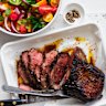 Barbecued lamb leg with tomato and mint.