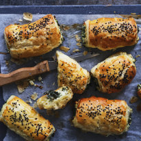 Kale and three-cheese pastries sprinkled with nigella seeds.