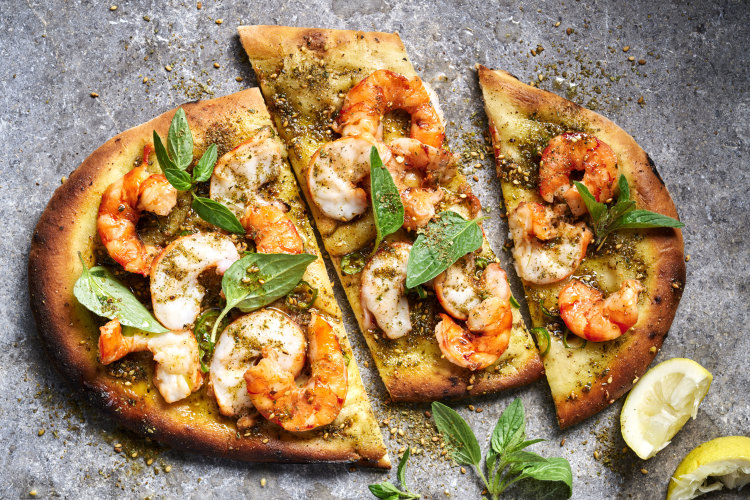 Be as generous with the prawns as you like when making these manoush-style pizzas at home.