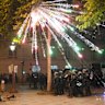Fireworks explode over riot police officers on the Champs-Elysees avenue after the Champions League final soccer match between Paris Saint-Germain and Inter Milan.