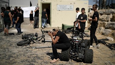 A woman from the Druze minority weeps near the site where 12 children and teens were killed in a rocket strike on a soccer field.