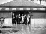 A family stands at the doorway of the doorway of its flooded home in Maitland, NSW, 8 August 1952.